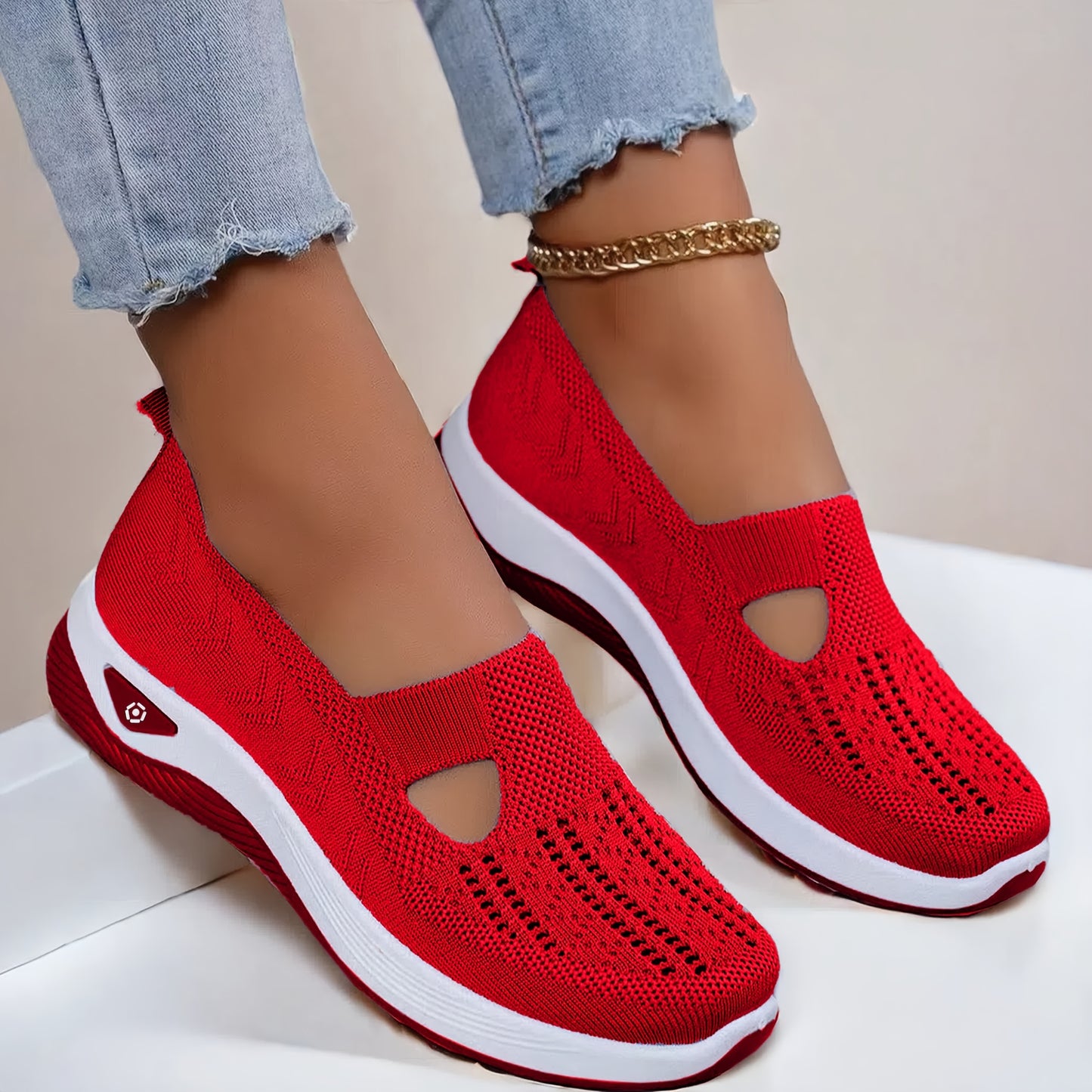 Lightweight and stylish knit sneakers for women in red, beige, green, blue, black, and purple. Features a cut-out design for breathability and a flexible sole for all-season wear.