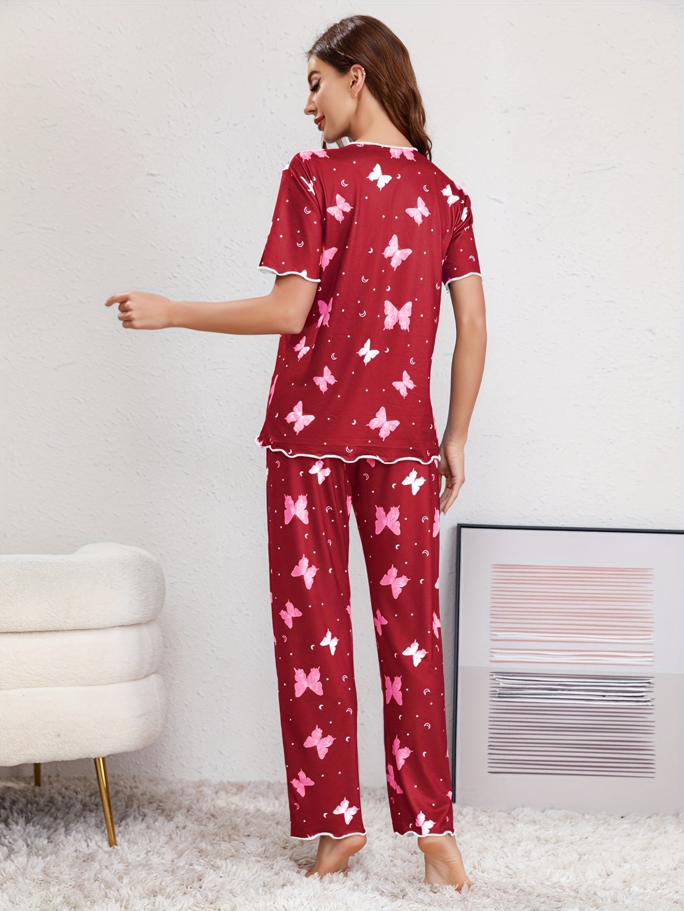 Butterfly print lounge set for women with lettuce trim, short sleeve top, and pants.