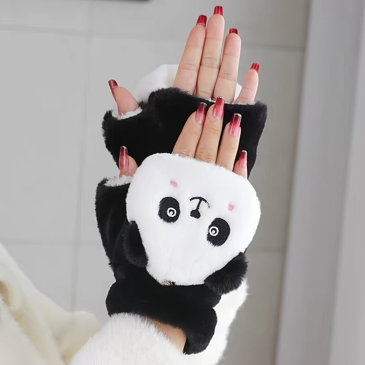 One pair of adorable animal cartoon-themed women's polyester winter mittens with flip tops. These thick, plush fingerless mitts provide warmth and decoration, perfect for casual weekend use. The embroidered design adds a touch of charm to this