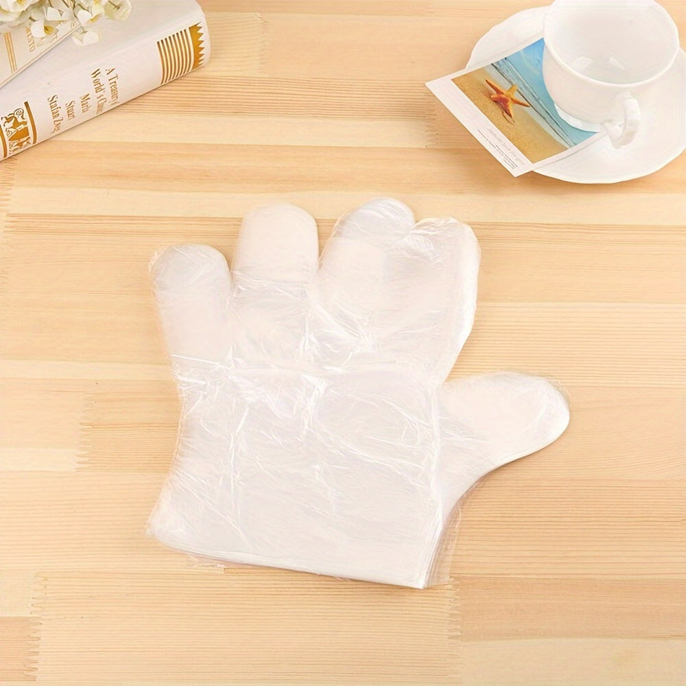 Disposable plastic BBQ gloves in a set of 90-100 pieces, transparent and designed to protect your hands while handling food for healthier cooking.