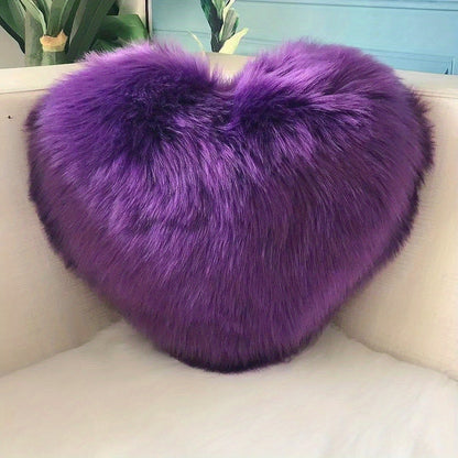 Heart-shaped throw pillow for living room or bedroom, made of long plush material for softness and comfort.