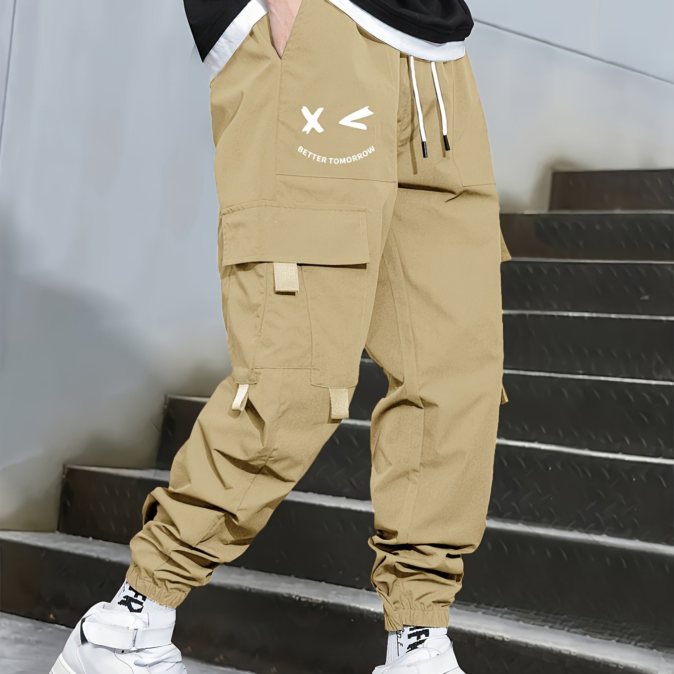 Stylish cargo pants with multiple pockets for men, featuring a loose fit and drawstring waistband for a casual outdoor streetwear look.