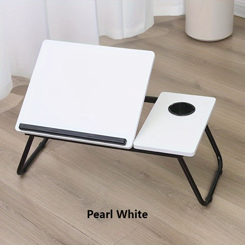 Adjustable bed desk with cup holder for laptop; portable, foldable lap desk for lazy computer use, made of wood fiber board.