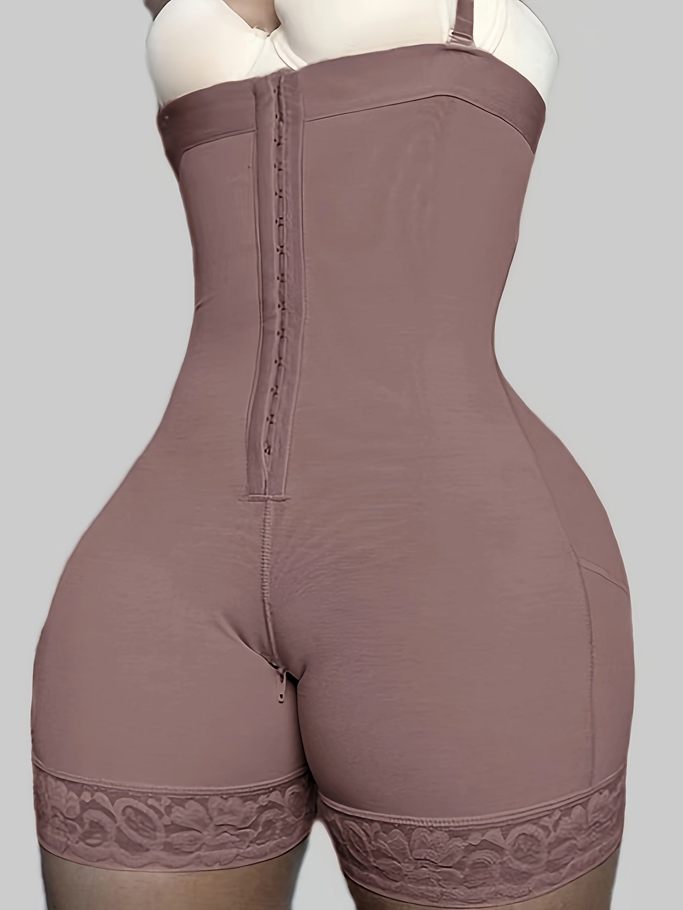 Enhanced bodysuit with high-waisted, body-shaping design, three buttons, zipper crotch, suspenders for tummy control, and lifting buttocks.