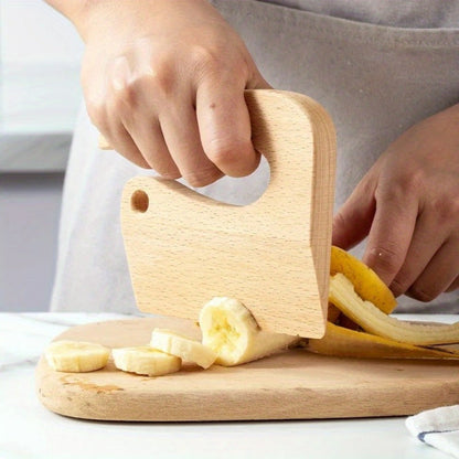 One piece of pretend cooking toys, including toy knives, sliceable fruits and vegetables, kitchen play sets, and wooden cutting utensils for faux food preparation.