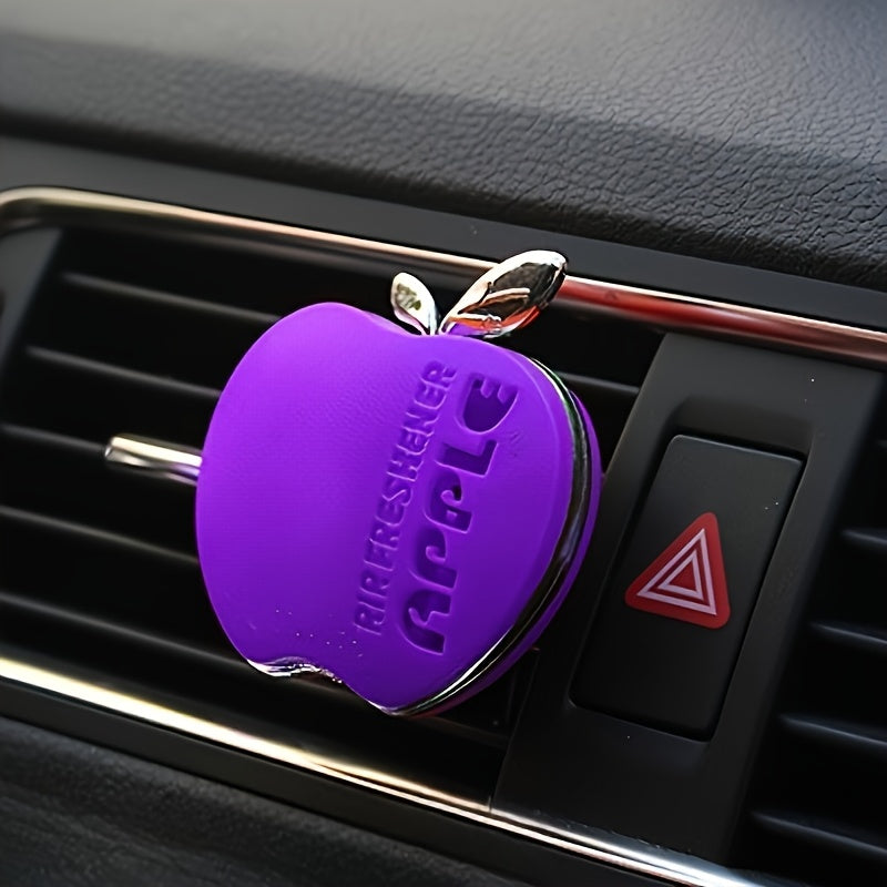 Apple-shaped car air freshener with aromatherapy perfume diffuser and vent clip fragrance dispenser. Includes balm/tablet/incense stick for portable auto scent enhancement.