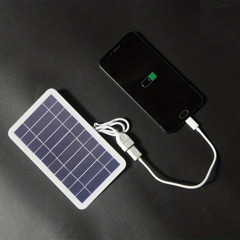 Portable USB solar panel charger for outdoor use, ideal for camping, travel, and emergencies. Charges mobile phones, flashlights, and fans. White solar charger with USB ports for on-the-go