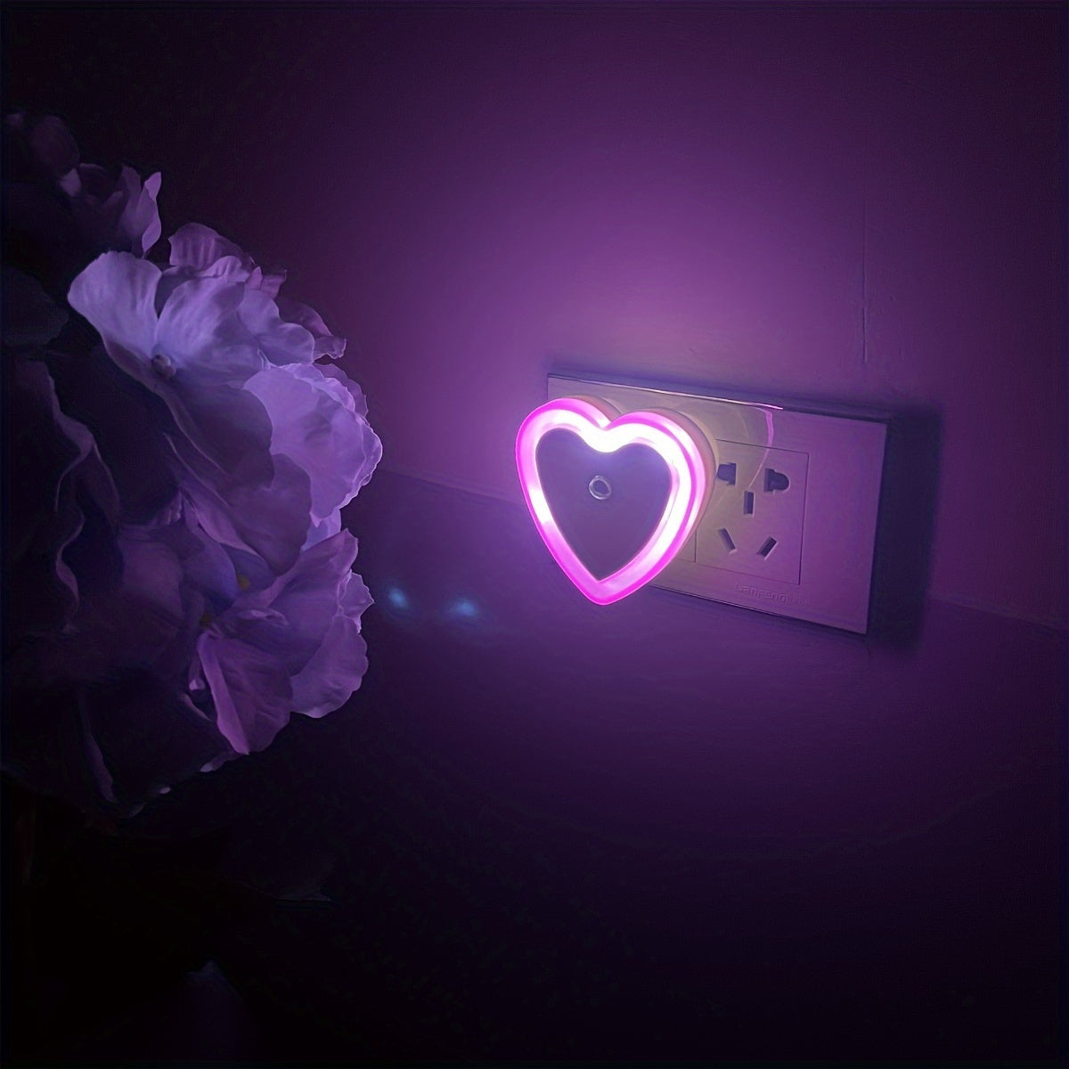 Heart-shaped LED night light with built-in sensor and European plug for indoor use. Ideal for stairways, bedrooms, kitchens, and hallways. Not waterproof. Can be wall-mounted.