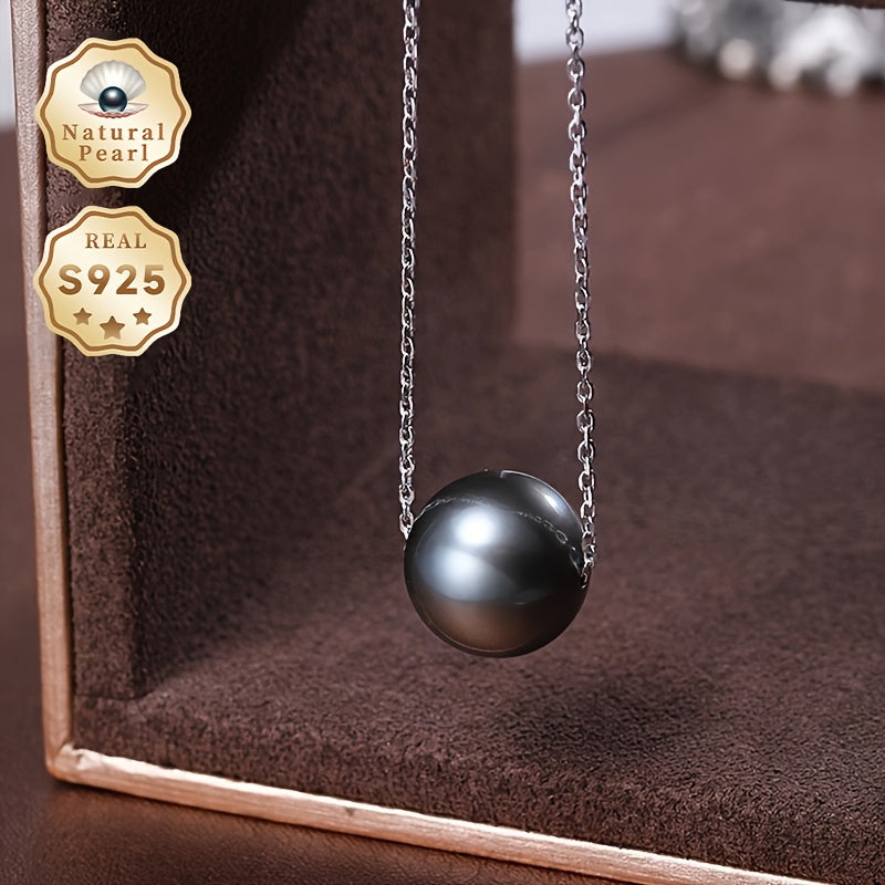 This necklace features a stunning large grain round Tahitian black pearl pendant suspended on a S925 silver chain. Each pearl is unique, so the color and shape may vary. This simple yet elegant piece is perfect for any woman's fashion collection and