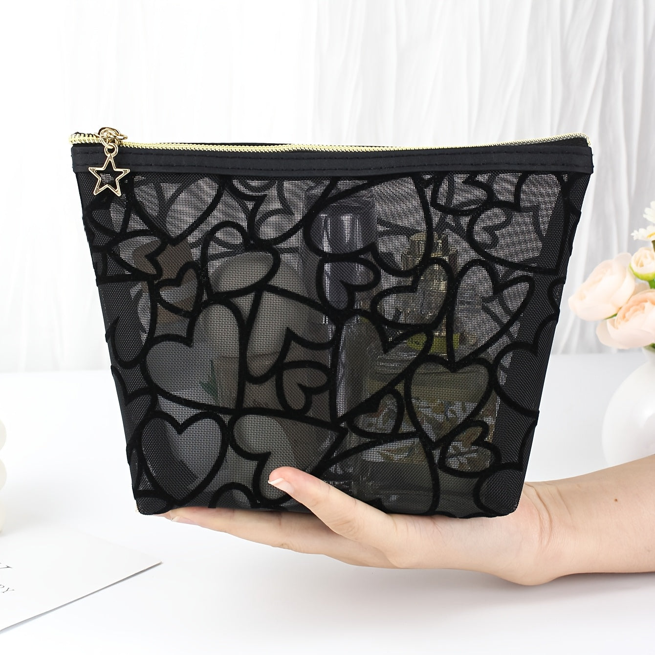 Black waterproof mesh makeup bag with a large capacity, zipper closure, and portable design for travel and toiletries.