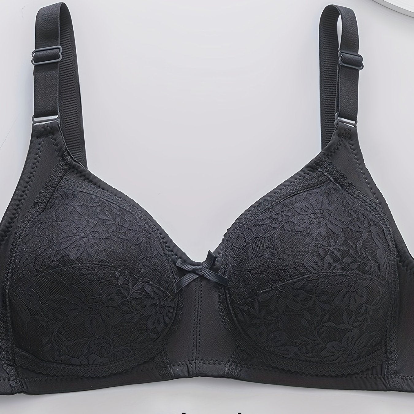 Wireless lace push-up bra for plus size women with triple hook closure, made of breathable nylon and spandex blend.