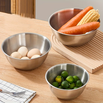 Set of 3 stainless steel mixing bowls with measurement marks, ideal for cooking and baking in kitchens and restaurants.