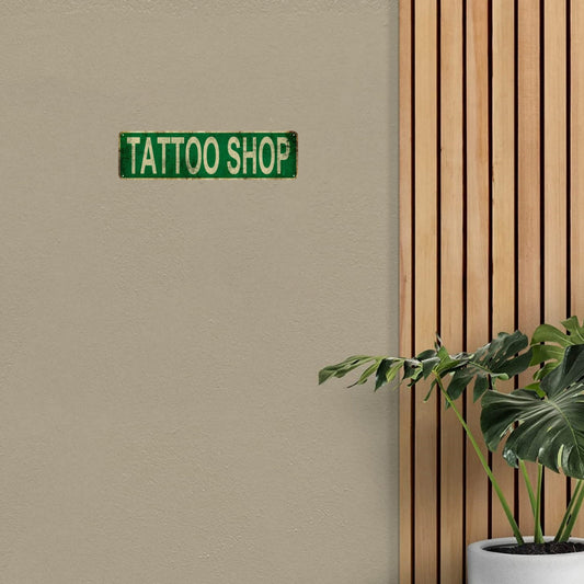 Get a 1pc Tattoo Shop Metal Tin Sign for your home or business. This novelty street sign measures 15.75"x3.94" (40x10cm) and can be used for home decor, room decor, wall decor, restaurant decor, bar decor, cafe decor, garage decor, or farmhouse decor.