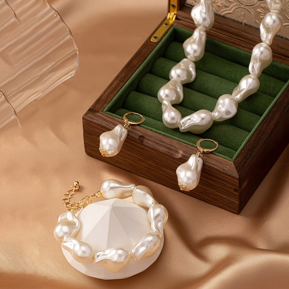 This women's jewelry set features elegant imitation pearls with a simple, un-plated design. The set includes a baroque pearl necklace, bracelet, and earrings, making it versatile for everyday wear. The unique geometric shape design adds a touch of