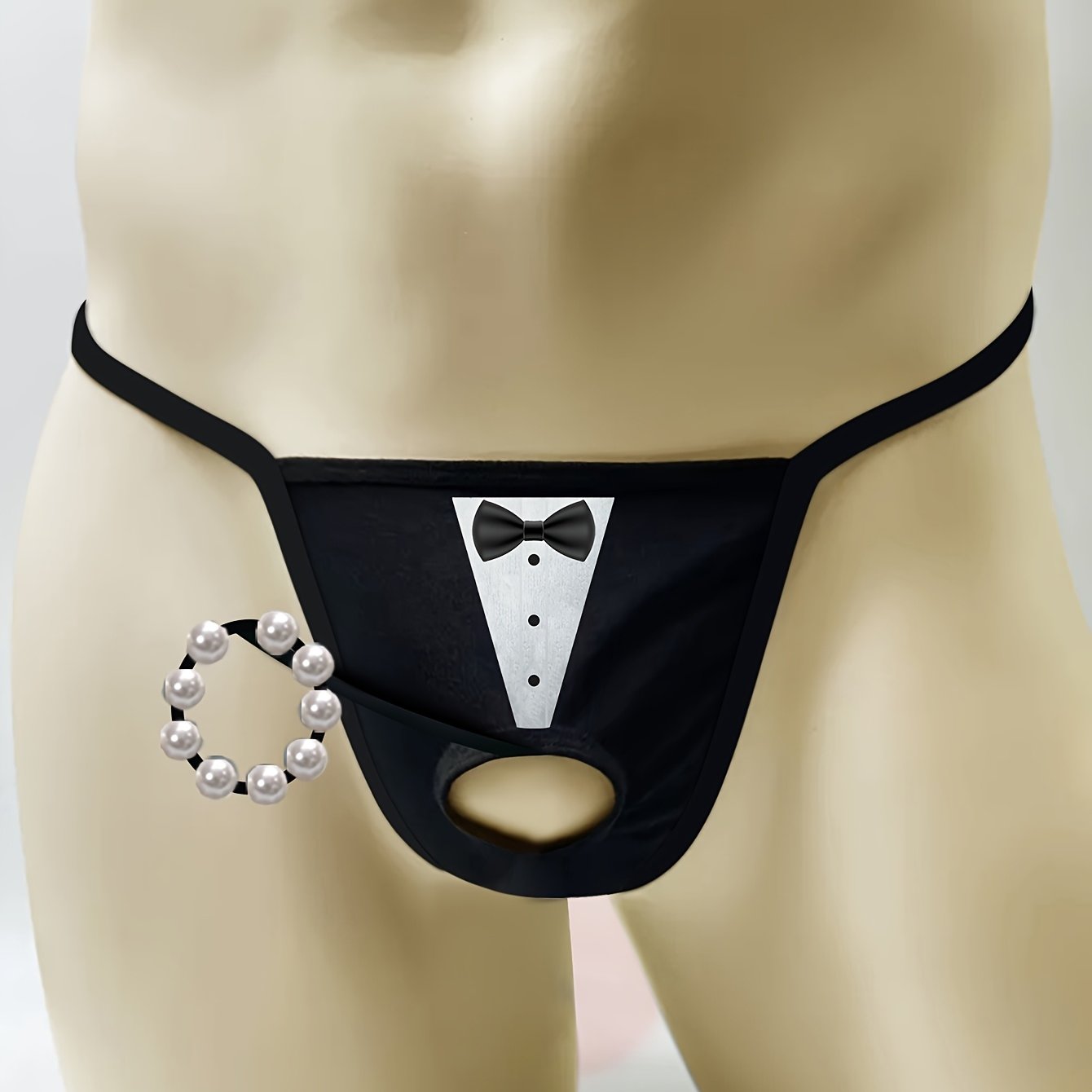 Men's novelty tuxedo print thong with beaded chain detail. Sexy lingerie in medium stretch knit fabric for a skinny fit. Ideal as a costume accessory.