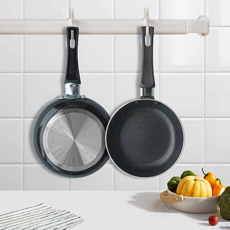 Small nonstick omelet and pancake pan, measuring 13.97 cm - Made from dishwasher safe aluminum with a silicone handle and 5-layer nonstick coating - Resistant to warping and scratching, ensuring a smooth surface for non-induction cooktops.