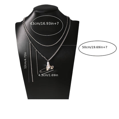 This Unique Pin Pendant Necklace features an elegant asymmetrical chain design adorned with Zirconia and Faux Pearl accents. Perfect for dressing up casual attire or as a thoughtful gift, this creatively designed pendant adds a touch of sophistication to