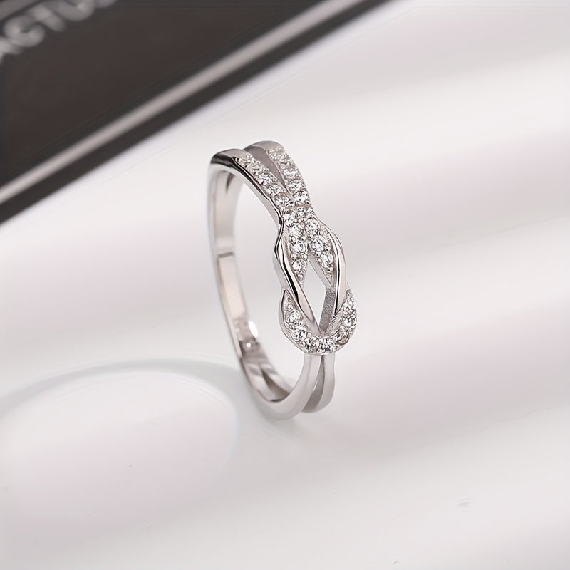 S925 sterling silver ring featuring a zirconia inlaid knot design, perfect for engagement, weddings, or as a stylish accessory for female party-goers.