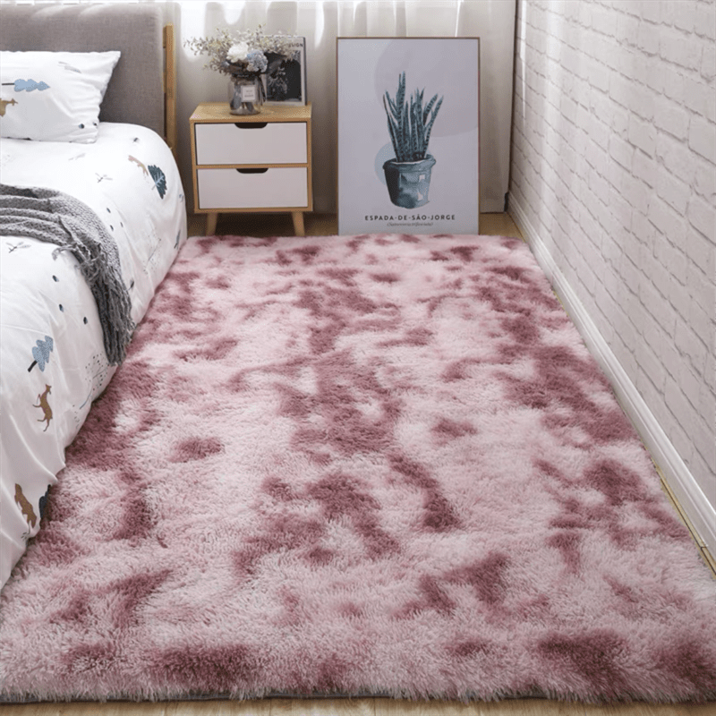 Soft fluffy area rug for bedroom, featuring a non-slip fuzzy shag plush design. This shaggy bedside rug is perfect for girls, kids, babies, teens, and dorm rooms. The tie-dyed pattern adds a fun touch to any living room or nursery. Measures 31.5*62.99