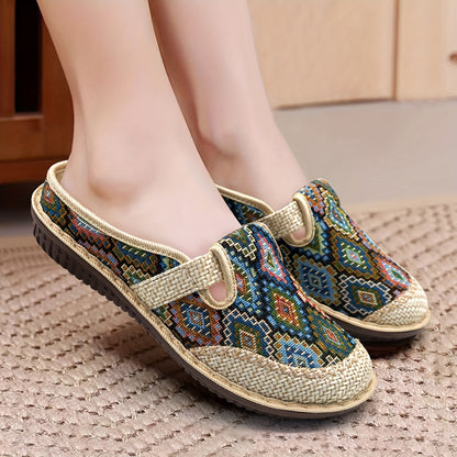 Women's printed slip-on mules with soft, lightweight soles.