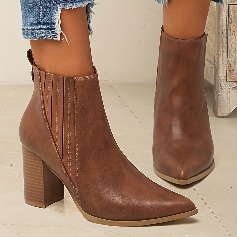 Trendy slip-on ankle boots in solid colors with chunky heels and a pointed toe.