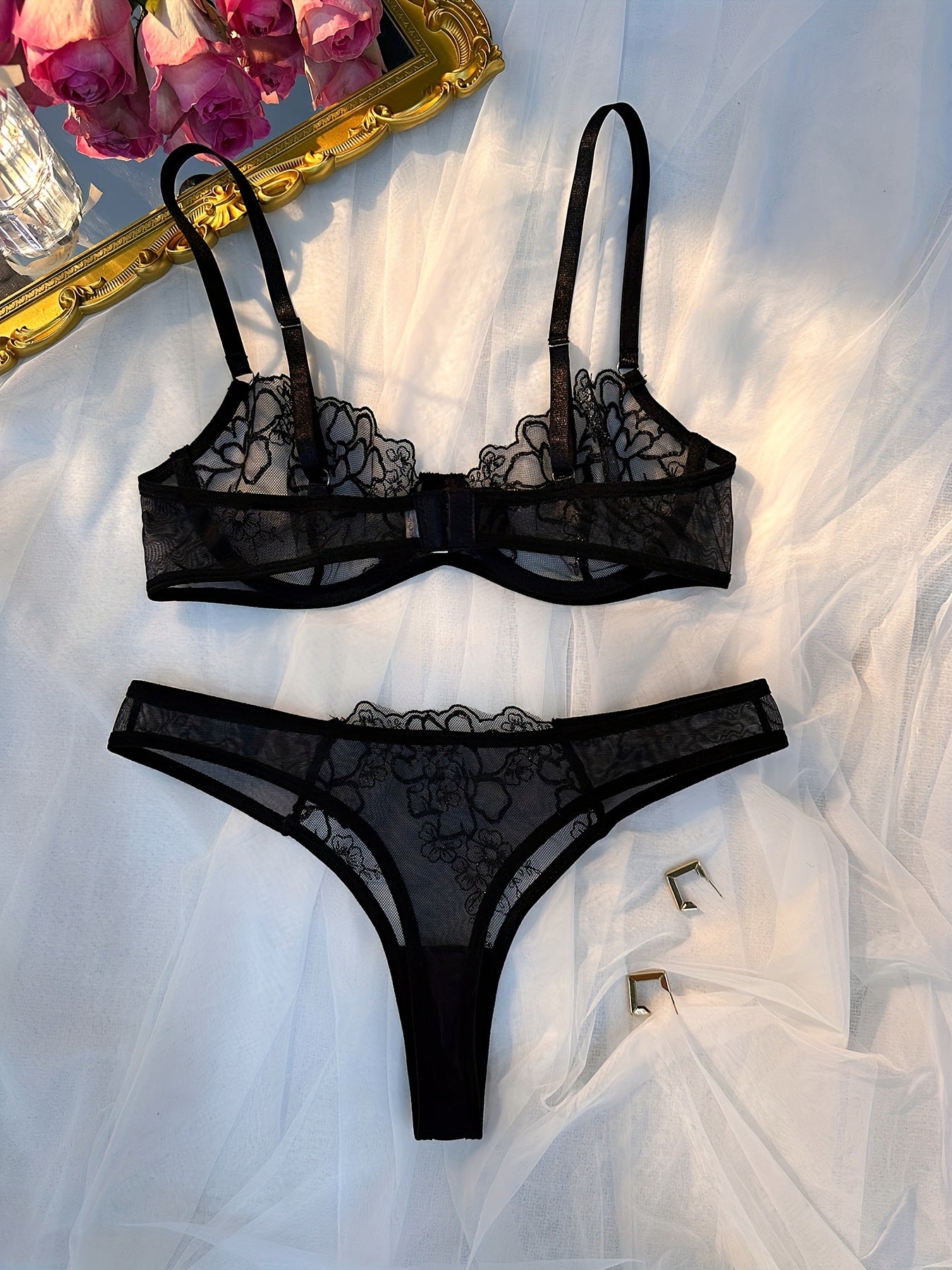 Women's sexy lingerie set includes sheer unlined bra and mesh thong with floral lace detailing.