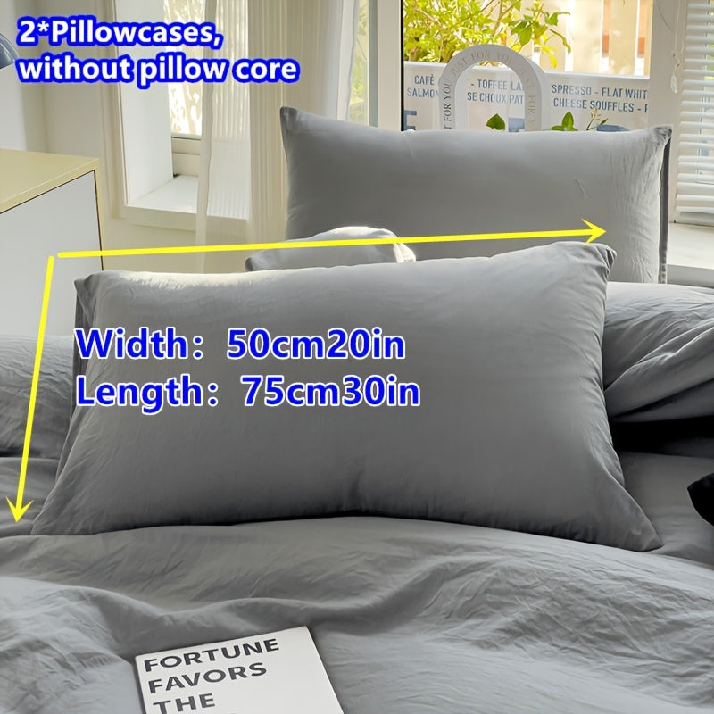 Two polyester pillowcases for bedroom use, featuring a multi-colored solid design.