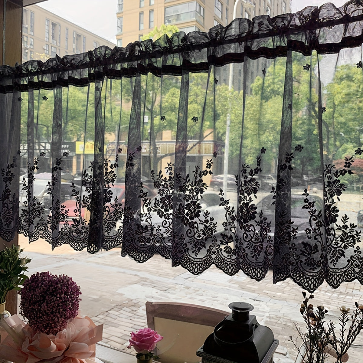 Elevate your space with this elegant black floral lace cafe curtain. Featuring a sweet and simple design, this curtain is made of sheer polyester and has a rod pocket for easy installation. Perfect for adding a touch of sophistication to your kitchen