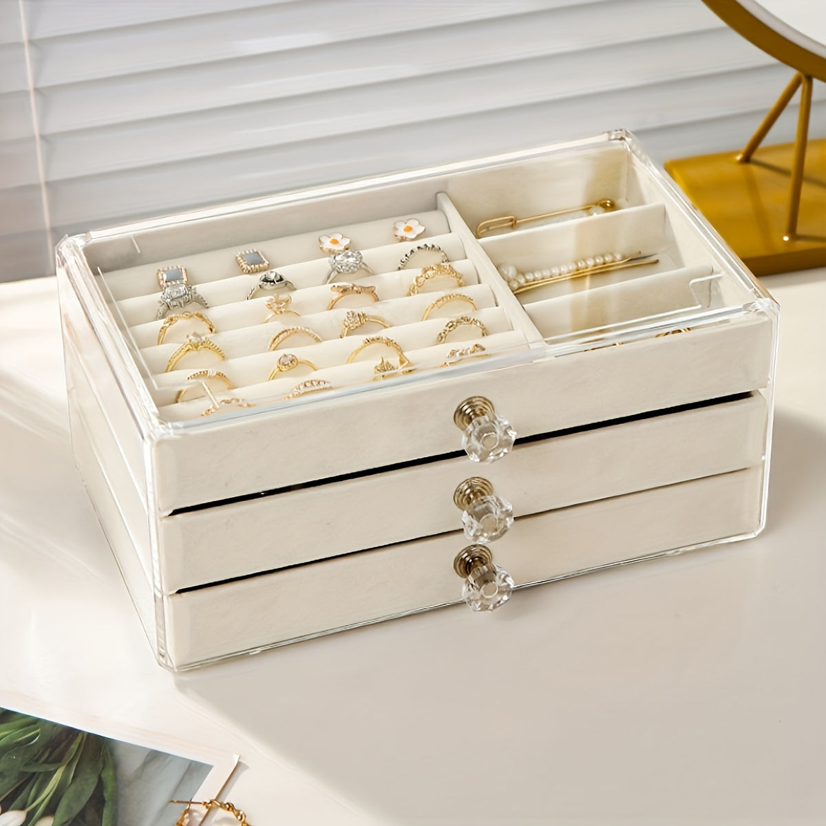 1 large drawer jewelry box with 3 layers for storing earrings, rings, necklaces, bracelets, and pendants on a desktop.