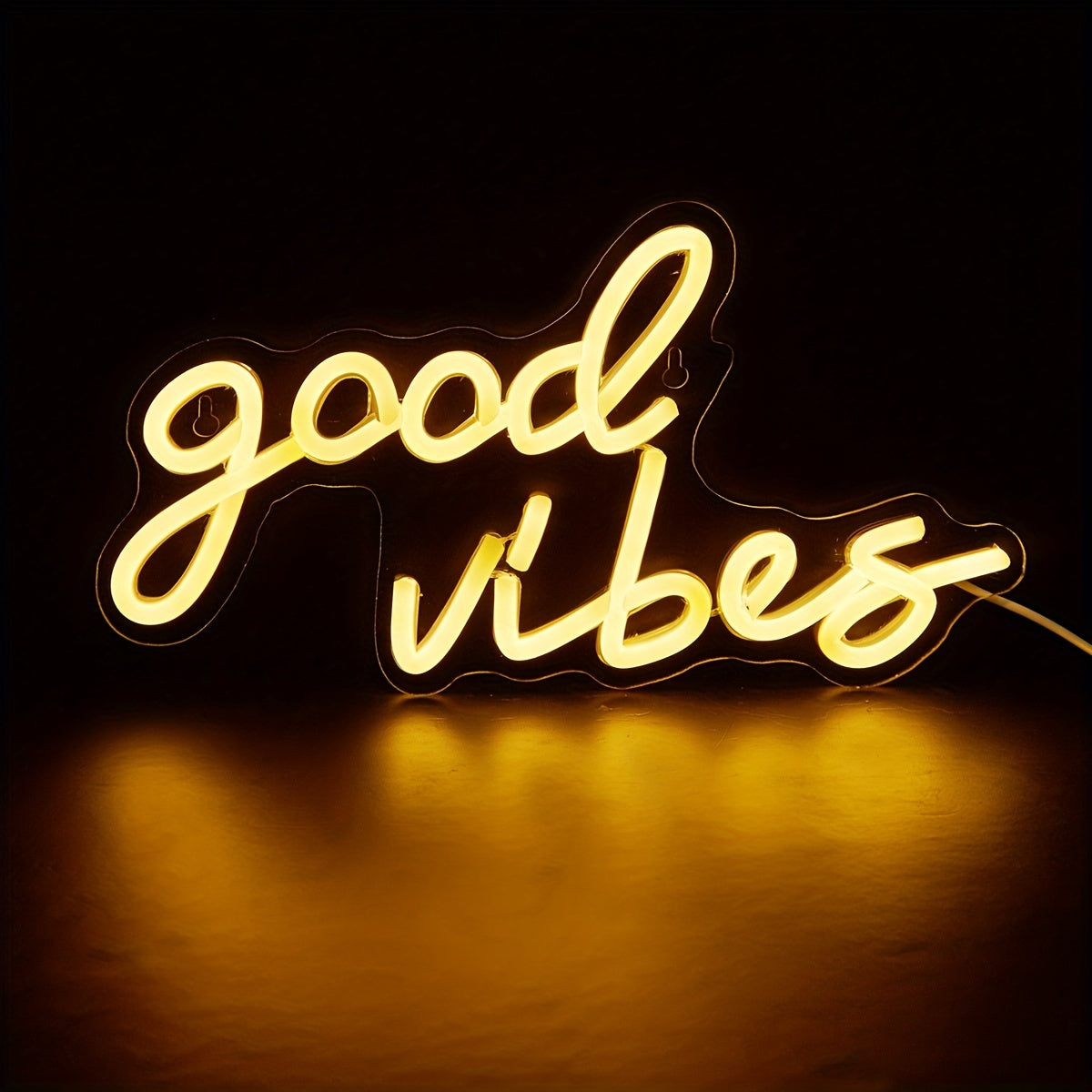 Pink cursive "Good Vibes" LED neon sign, USB powered for wall decor in bedroom, bar, or party atmosphere.