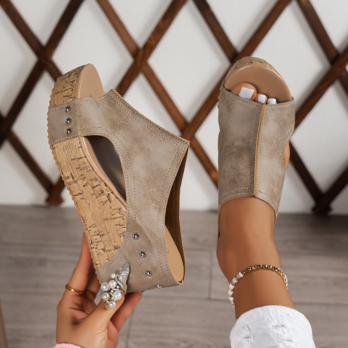 Women's platform sandals with studded decor and wedge heel.