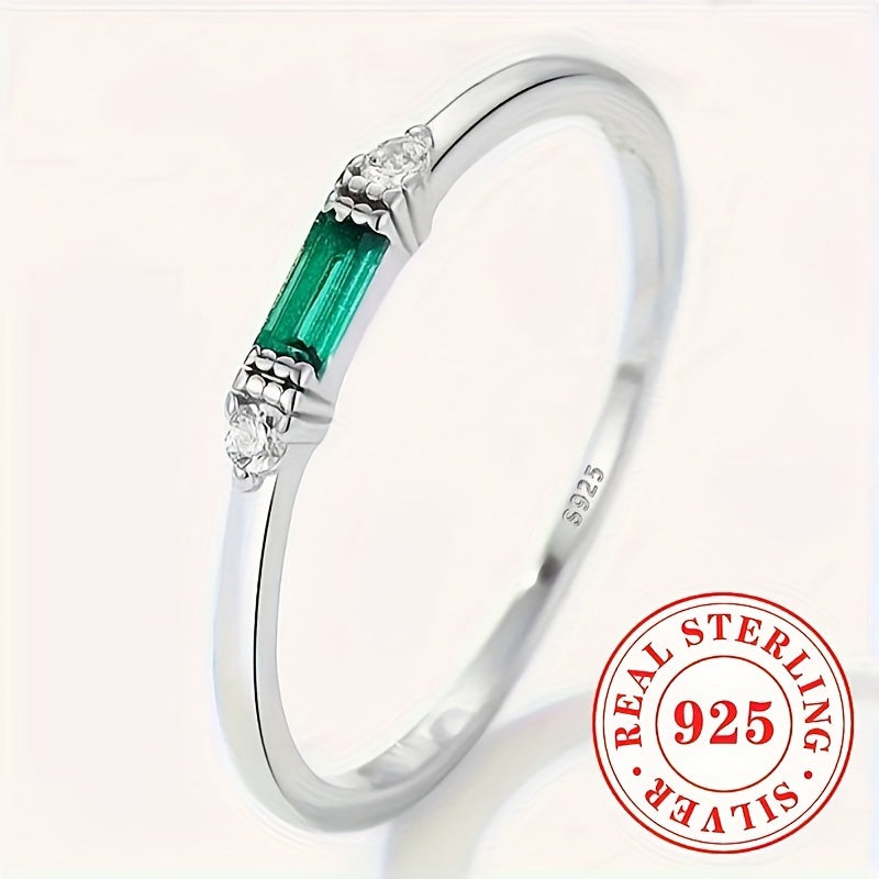 Delicate Sterling Silver Ring adorned with Baguette Cubic Zirconia and a Synthetic Green Gemstone, perfect for everyday wear or special occasions. This elegant piece is suitable for stacking and makes a thoughtful gift for women.