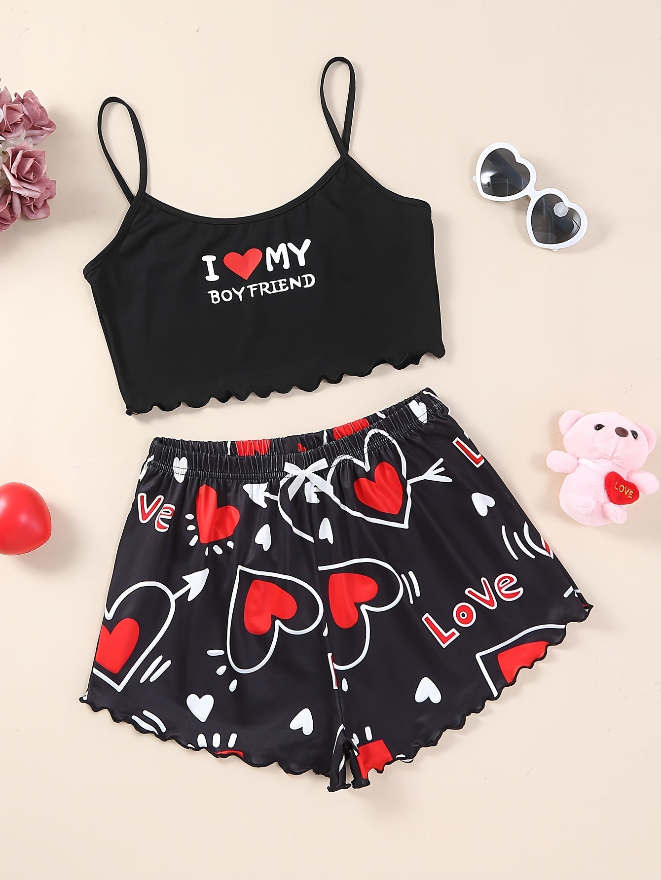 Valentine's Day pajama set for women, featuring heart and slogan print cami top with lettuce trim crew neck and elastic shorts.