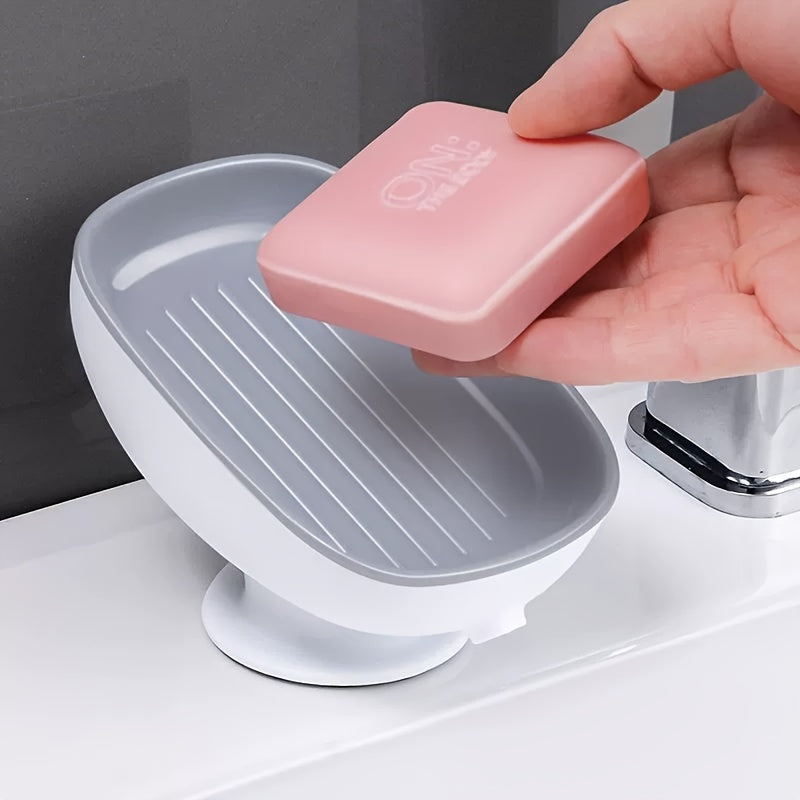 Suction cup soap dish with drainage for bathroom and kitchen sink storage.