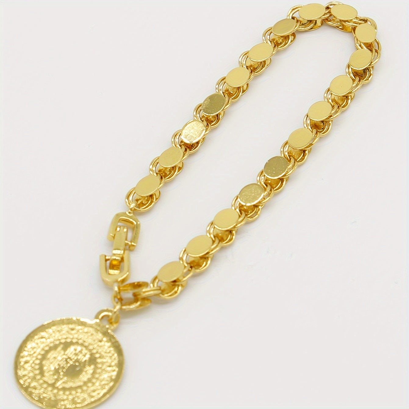 A handmade bracelet adorned with a gold-plated Turkish lira pendant, perfect for everyday or special occasions.