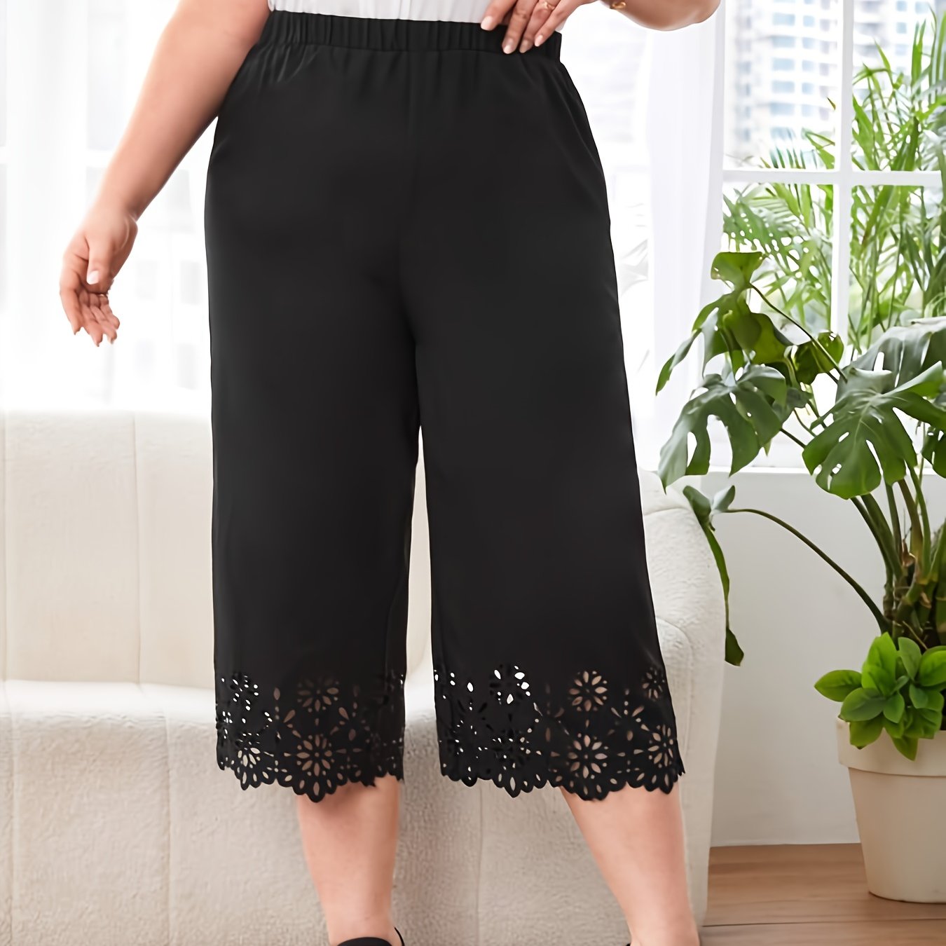 Plus size black capri pants with elastic waist and lace detail. Made of polyester fabric, suitable for spring/summer. Hand wash or dry clean. Casual cropped trousers.