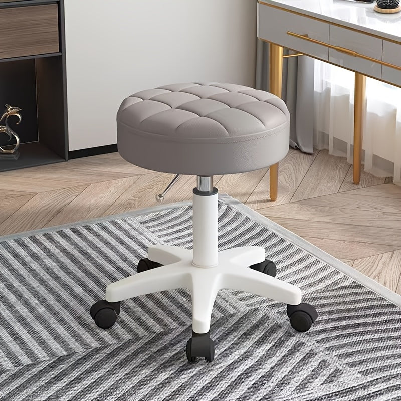 Black adjustable rolling stool with quilted plastic seat, height adjustment, perfect for salon professionals.