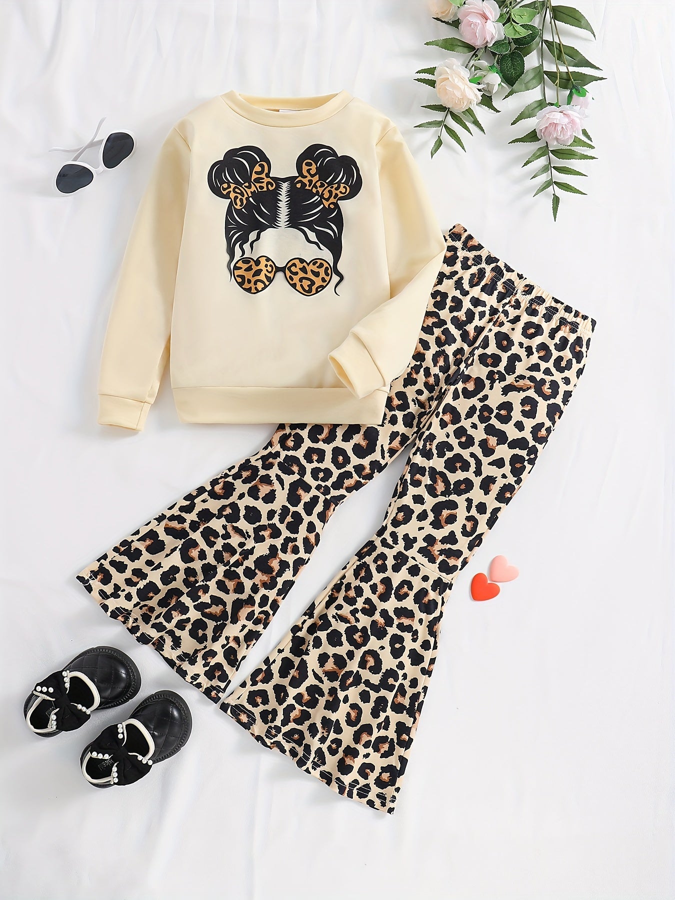 Girls' trendy 2-piece outfit includes a sweatshirt, leopard pattern flared pants, and sunglasses print. Perfect for spring and fall outdoor wear.