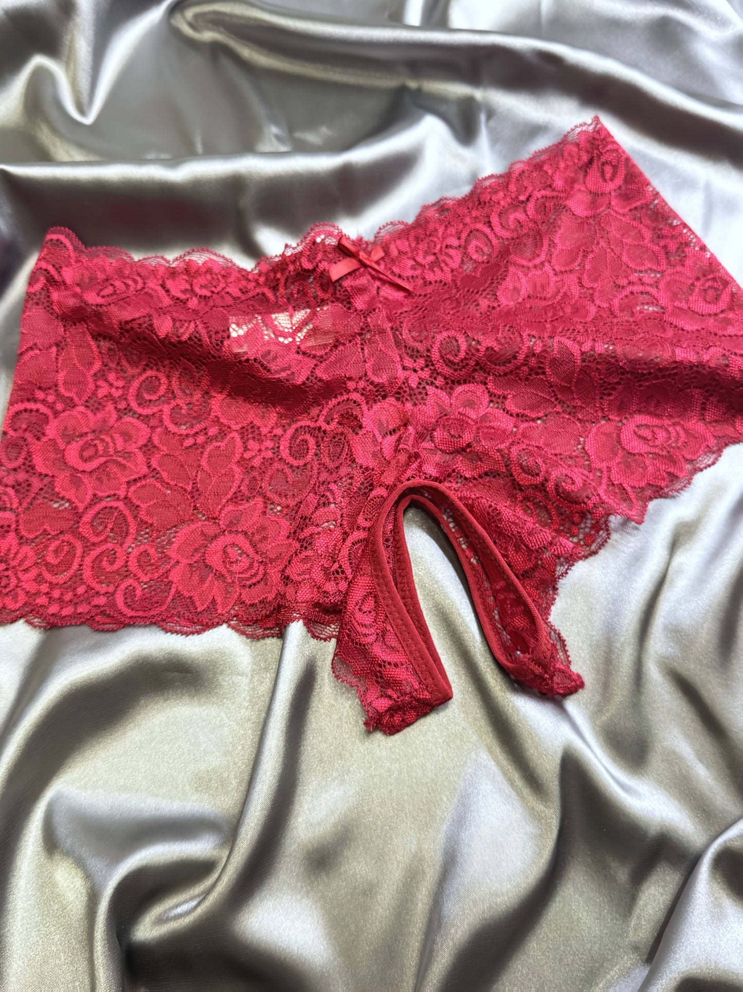 Valentine's Day lace open-crotch panties for women in red with bow details.