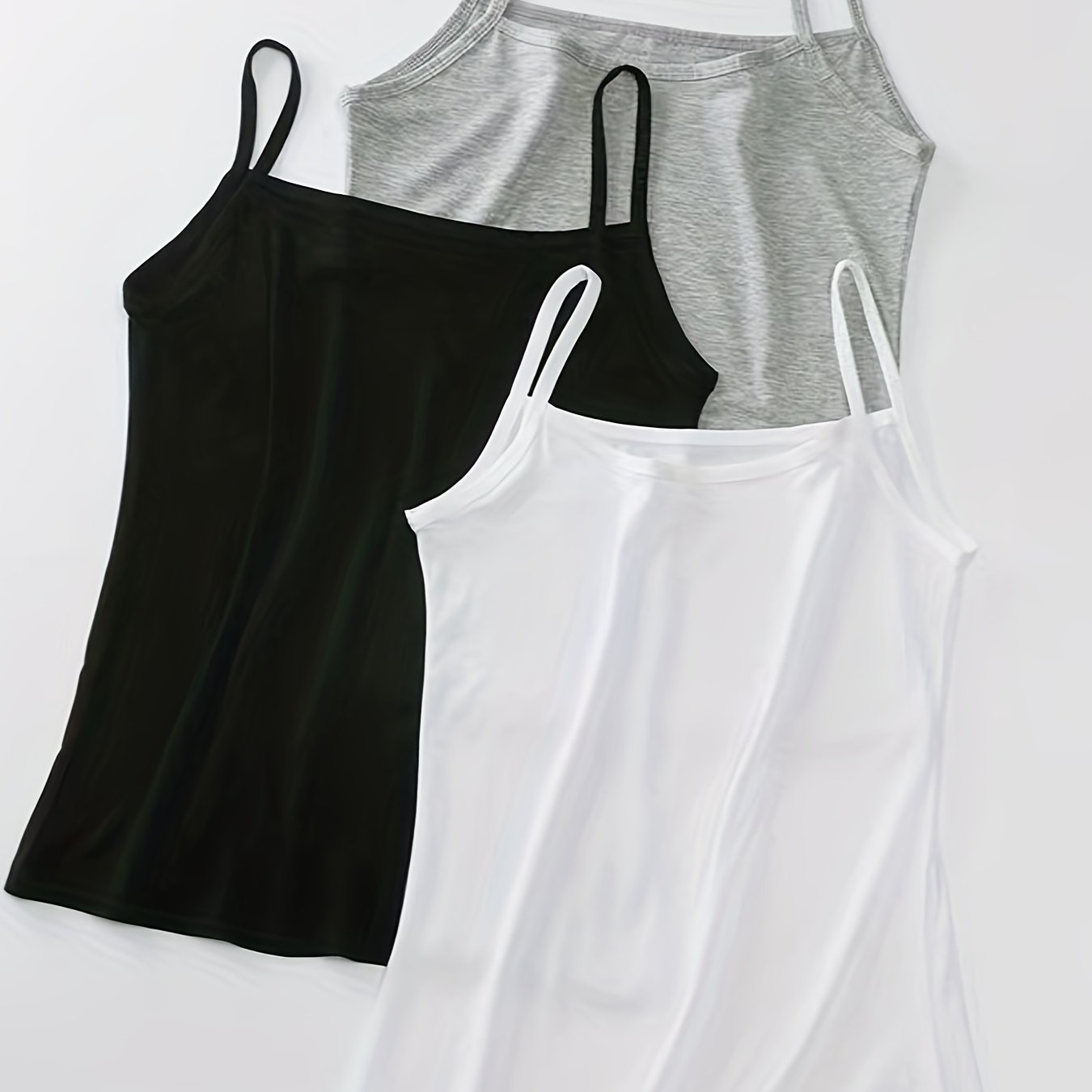 3 Women's Modal Camisole Tops in Black, White, and Gray, perfect for both casual wear at home and outdoor activities. Made with a stretchy spaghetti strap sleeveless design that is