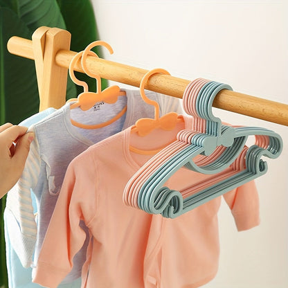 10 Newborn Hangers made of sturdy and durable PP material, designed with bow wardrobe storage for children aged 0-10 years old. Complete with hooks for easy hanging. Perfect for Christmas, Thanksgiving, New Year, Valentine's Day, and Easter gifts.