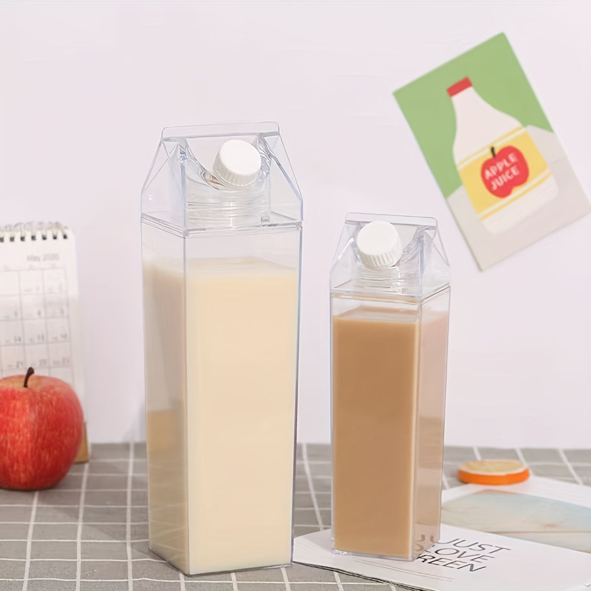 1pc of Creative Milk Carton Water Bottles made of transparent plastic, available in 500ml or 1000ml sizes. These reusable bottles feature a leak-proof screw cap and are ideal for carrying milk, juice, and tea for home or outdoor use.