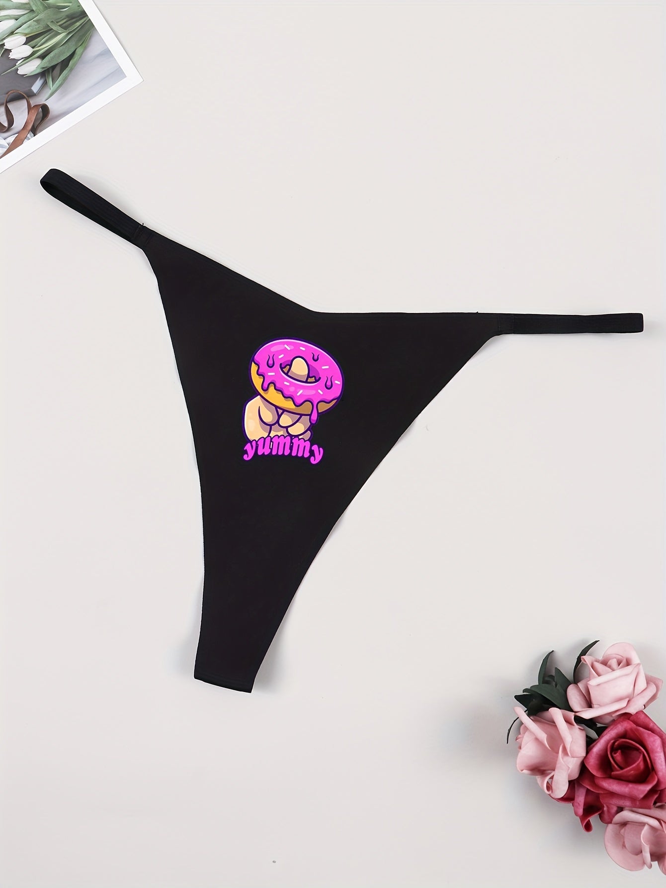 Sexy women's thong underwear featuring donut print and fun letter graphic, made of breathable quick-dry nylon fabric.