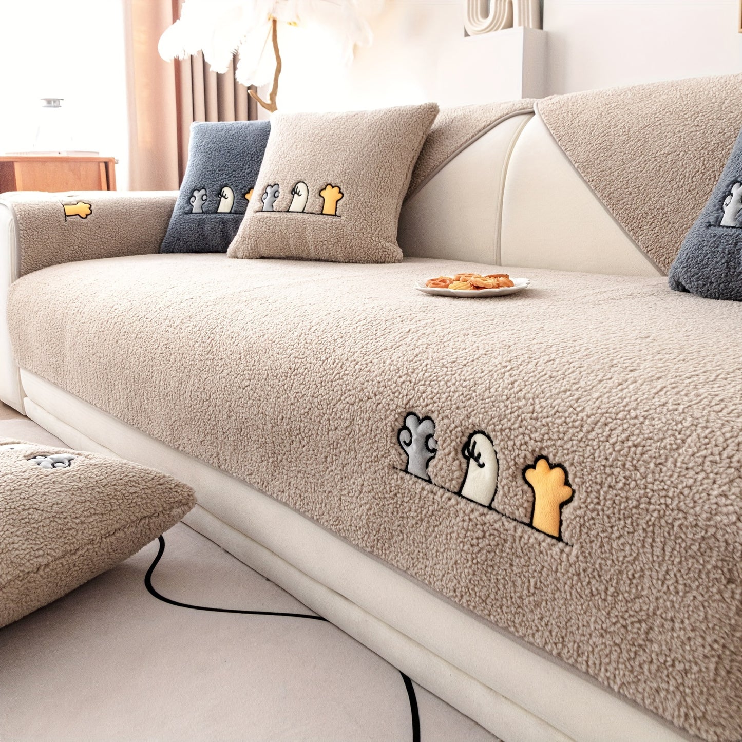 Modern plush sofa cover with paw pattern embroidery, non-slip protection for sofas, machine washable and suitable for various types of furniture.