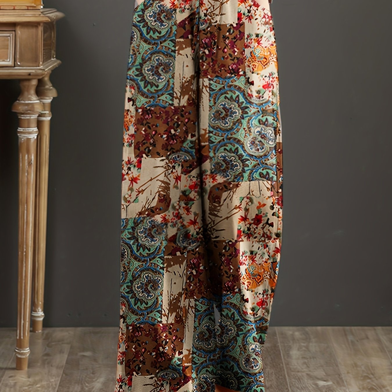 Floral cotton wide-leg pants with elastic waist, lace-up detail, and loose fit. Perfect for casual weekends and year-round comfort. Made with woven fabric for adults.