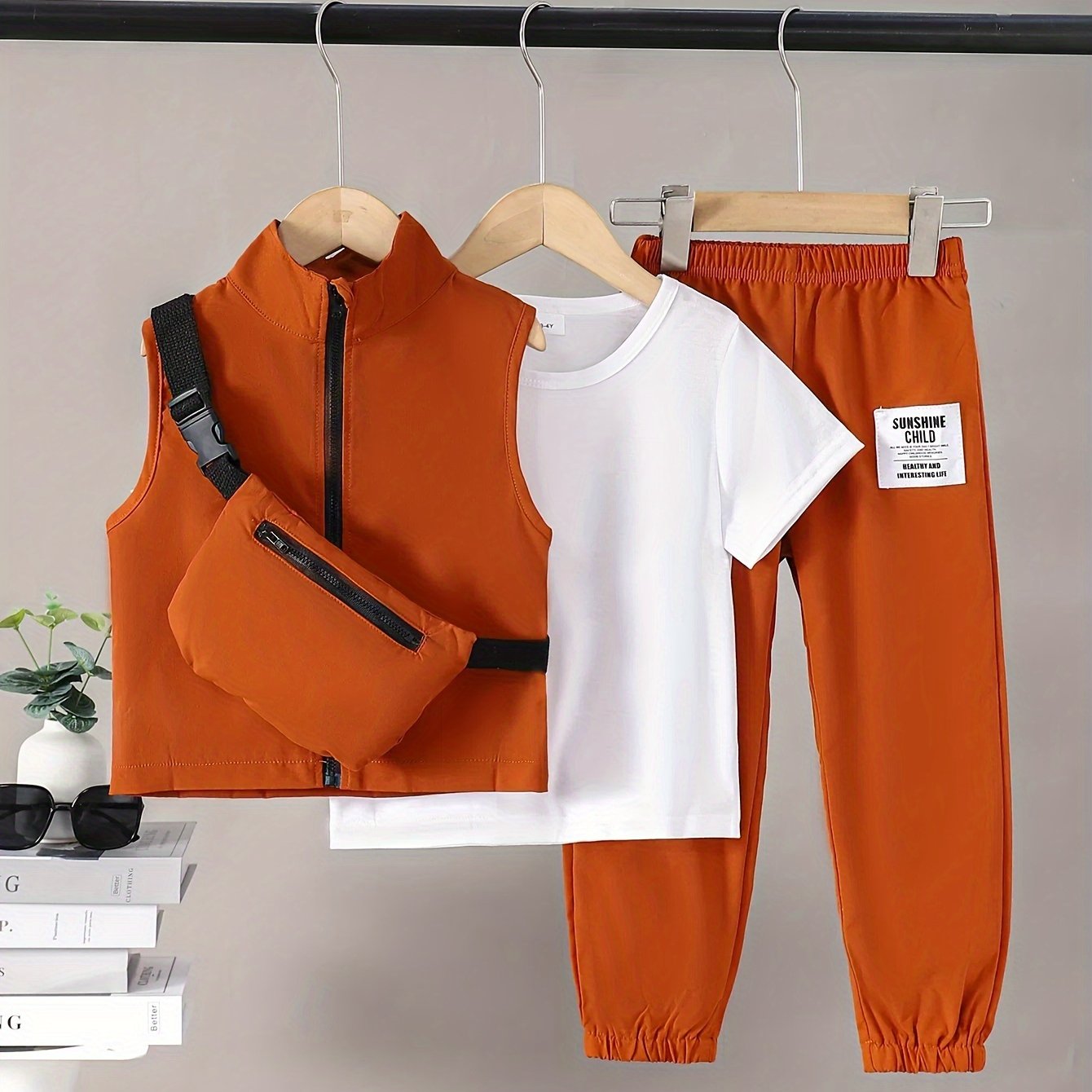 Boys 4-piece spring outfit: Short sleeve t-shirt, sleeveless vest, cargo pants, and crossbody bag. Cool, lightweight, and comfy for outdoor wear.