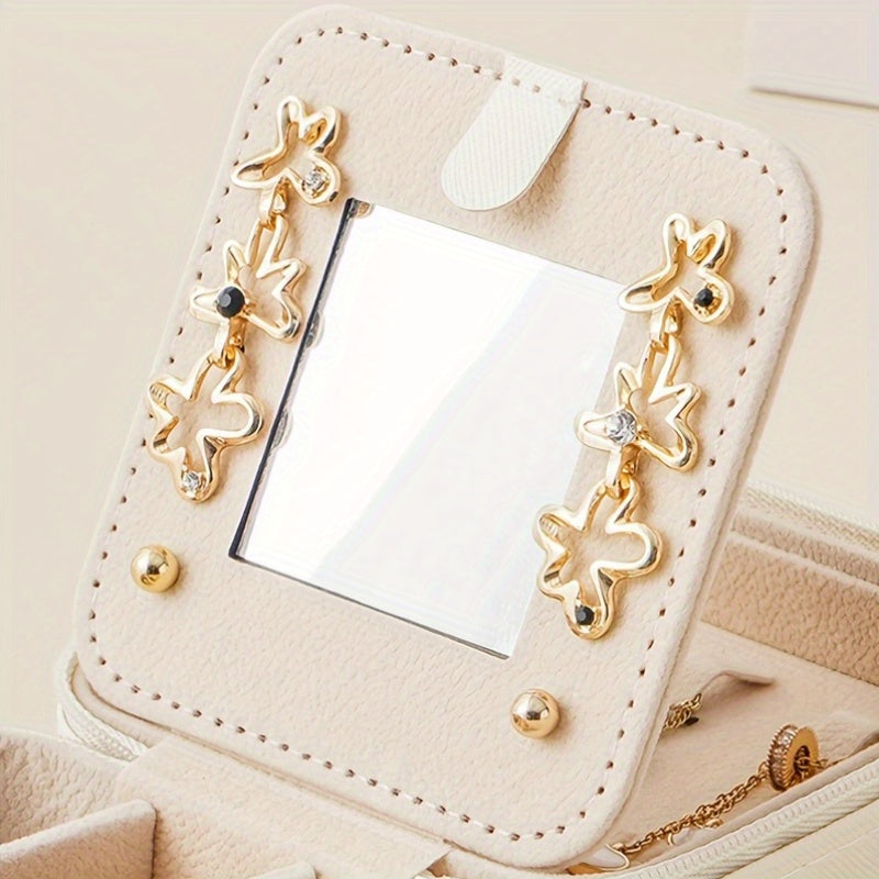 Compact and stylish portable jewelry box with mirror, zipper, and flip cover. Ideal for storing rings, earrings, and necklaces on-the-go.