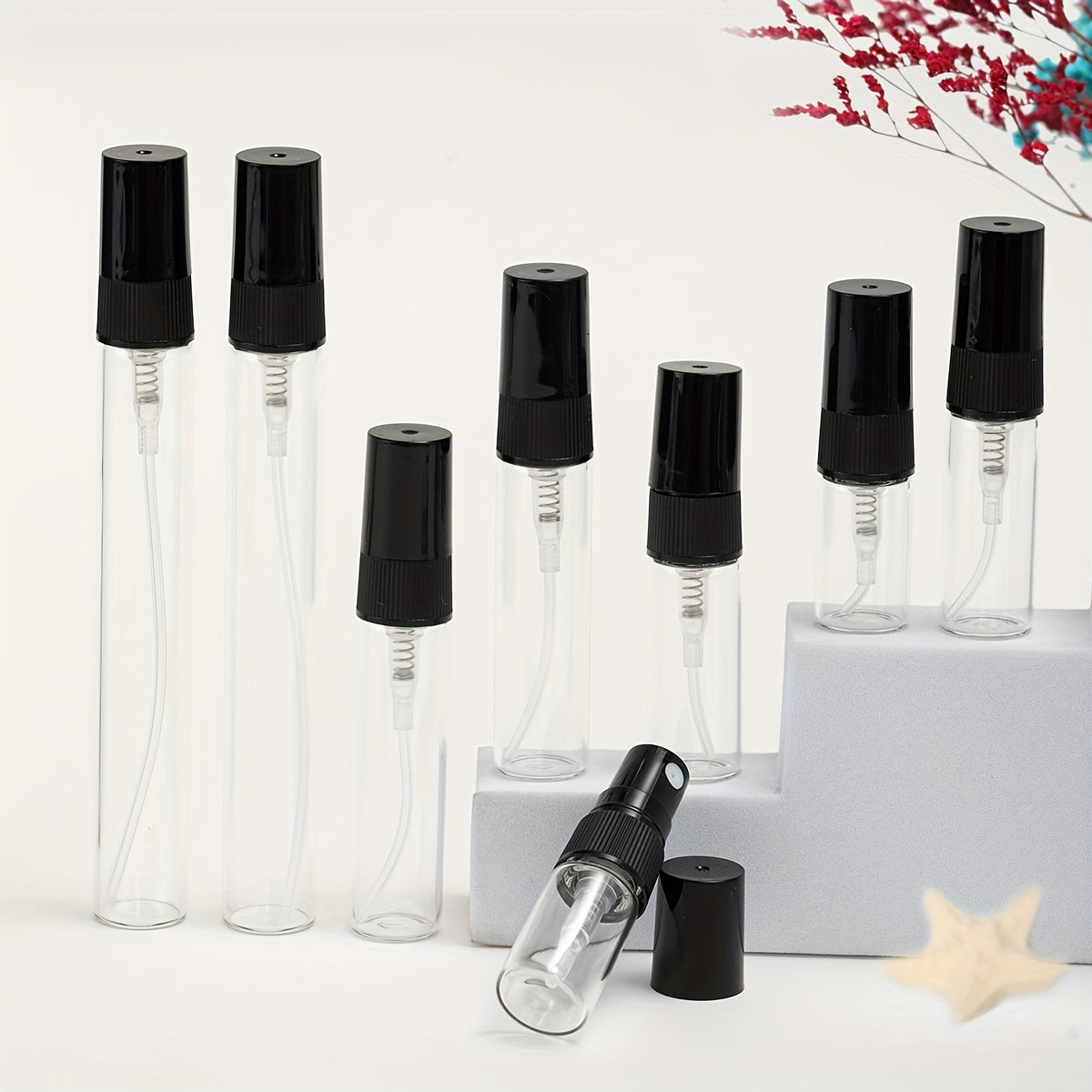 56 transparent glass perfume bottles with refillable spray nozzles in various sizes, ideal for travel and moisturizing.