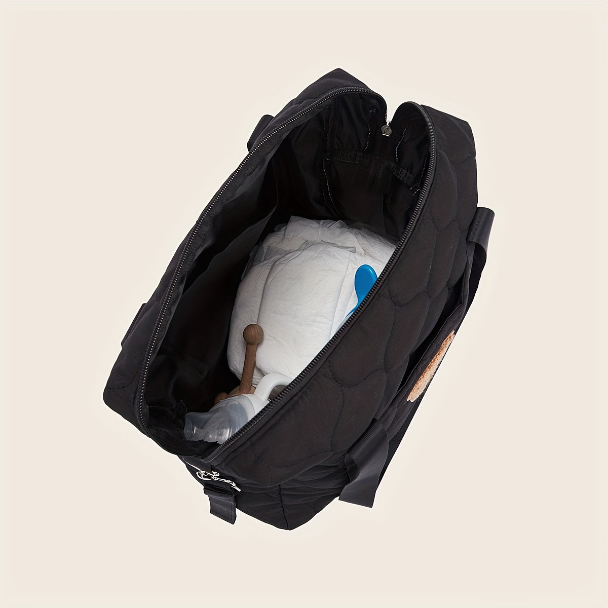 Large black parent bag with ample storage space, perfect for taking on the go. Features a shoulder strap for easy carrying.