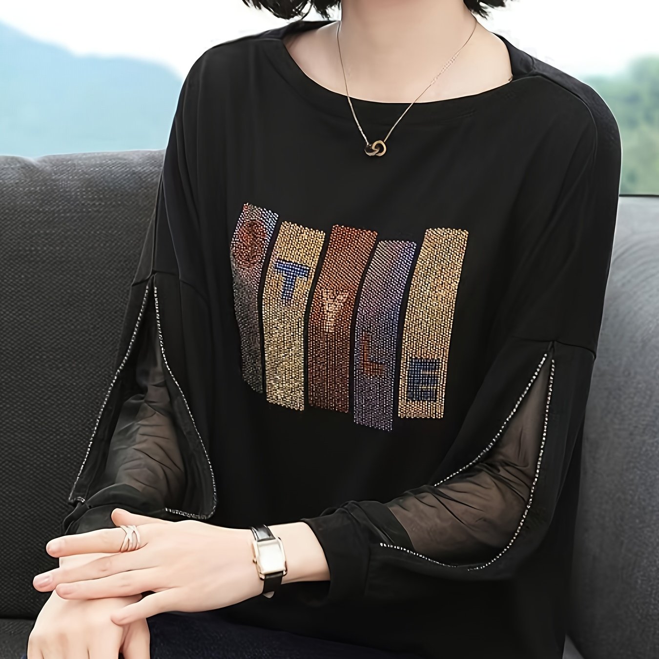 Women's rhinestone embellished loose-fit blouse with letter pattern design, made of polyester knit with mesh panels and a round neck for spring/autumn.